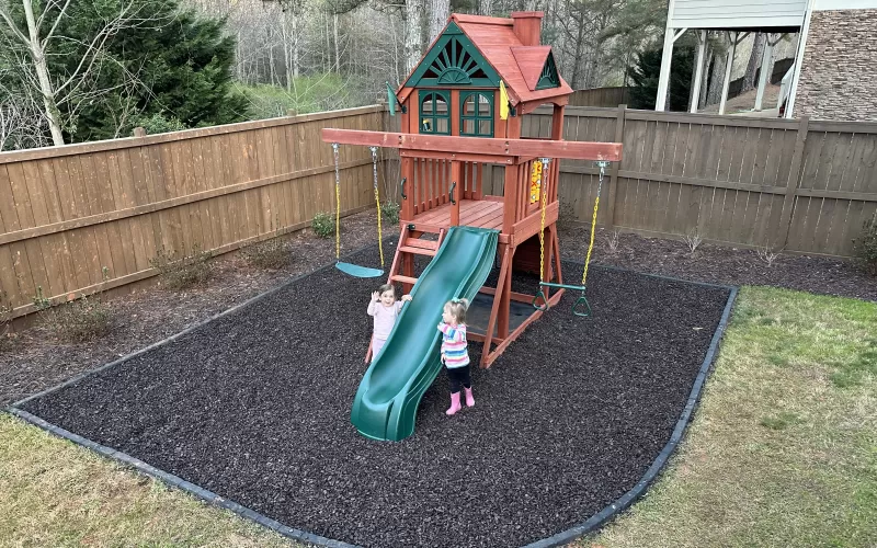 Brown Rubber Mulch Playground in Backyard
