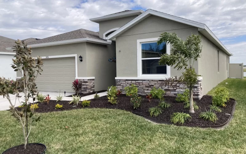 House with Brown Rubber Mulch Landscaping