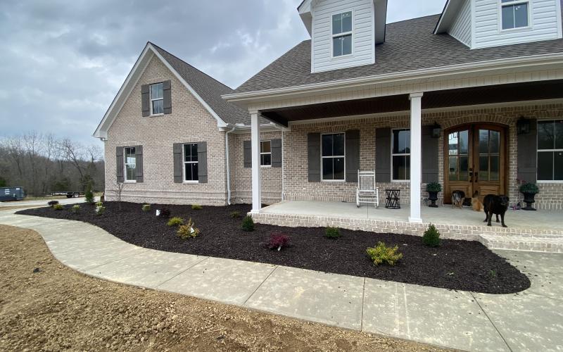 Rubber Mulch garden bed landscaping in front of house
