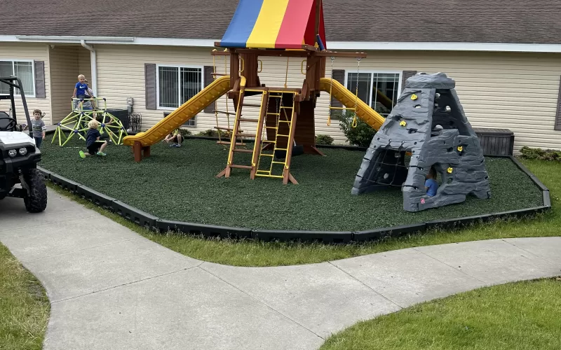 Playground with green rubber mulch and duratimber borders