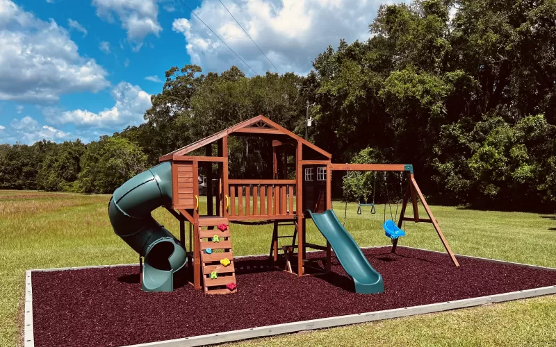 Playground with red rubber mulch ground cover