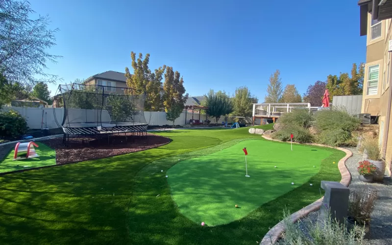 Rubber Mulch Under Trampoline in Fun Backyard