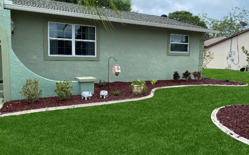 Landscaping with Red Rubber Mulch Beds Against the House