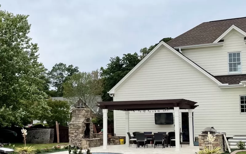 Green rubber mulch edging around a pool