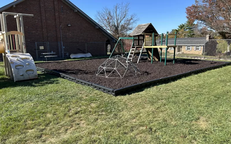 Playground Ground Surface of Brown Rubber Mulch and DuraTimber Borders 