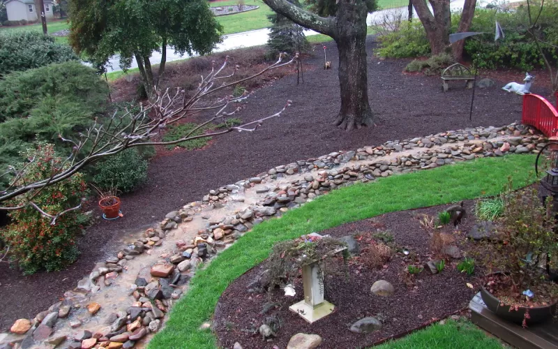 Brown Rubber Mulch Landscaping With a Creek