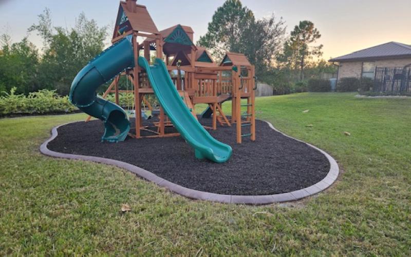 Playground with brown rubber mulch surface