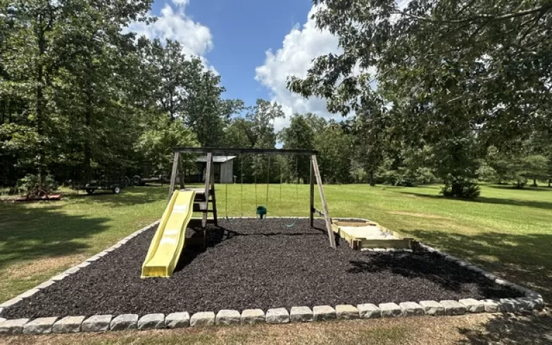 Brown Rubber Mulch Play Area with Stone Border
