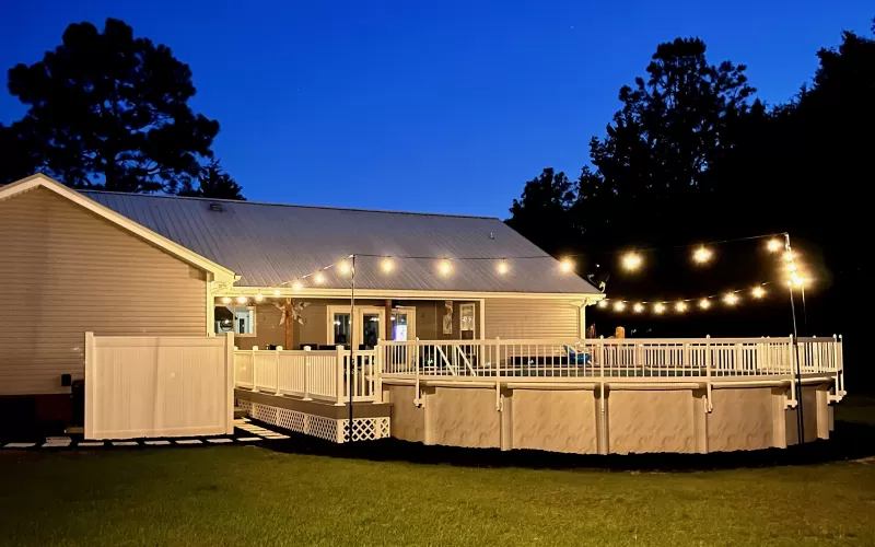 Pool and Deck with Rubber Mulch Edging at Night
