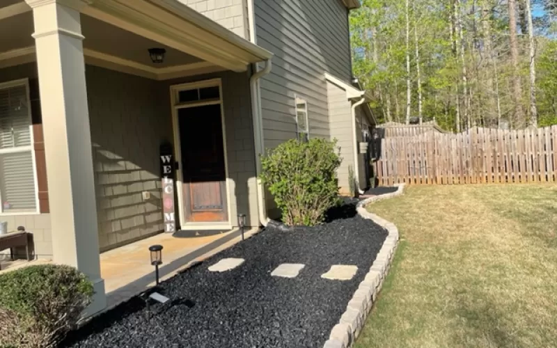 Front yard black rubber mulch garden bed