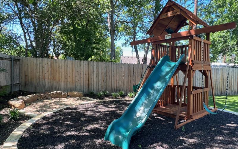 Play area with rubber mulch ground covering