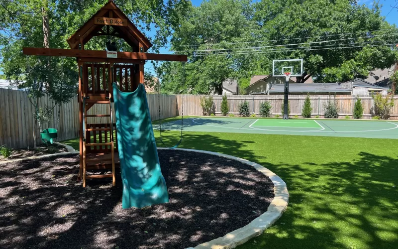 Brown rubber mulch playground and basketball court