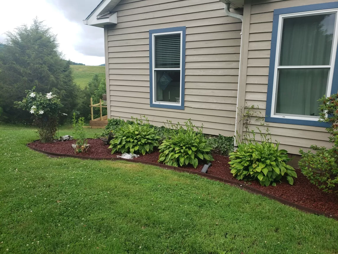 Red Rubber Mulch Garden Bed Next To House