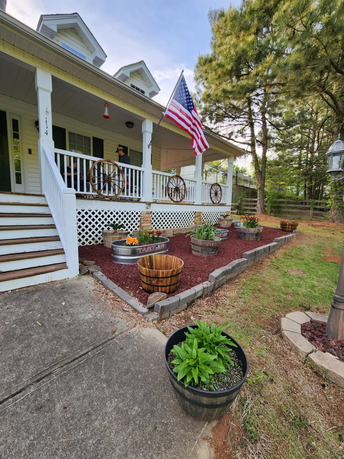 House with patio and red rubber mulch beds