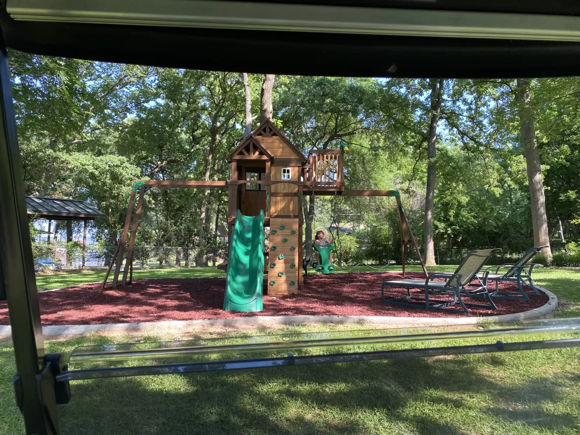 Grandkids playground with red rubber mulch