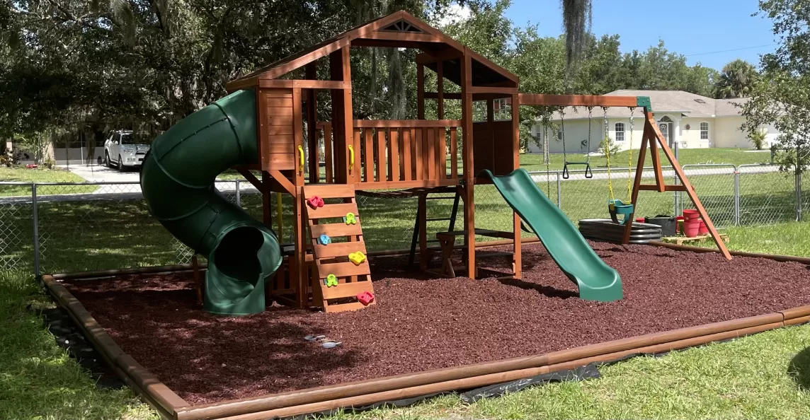 Red Rubber Mulch Playground in Backyard