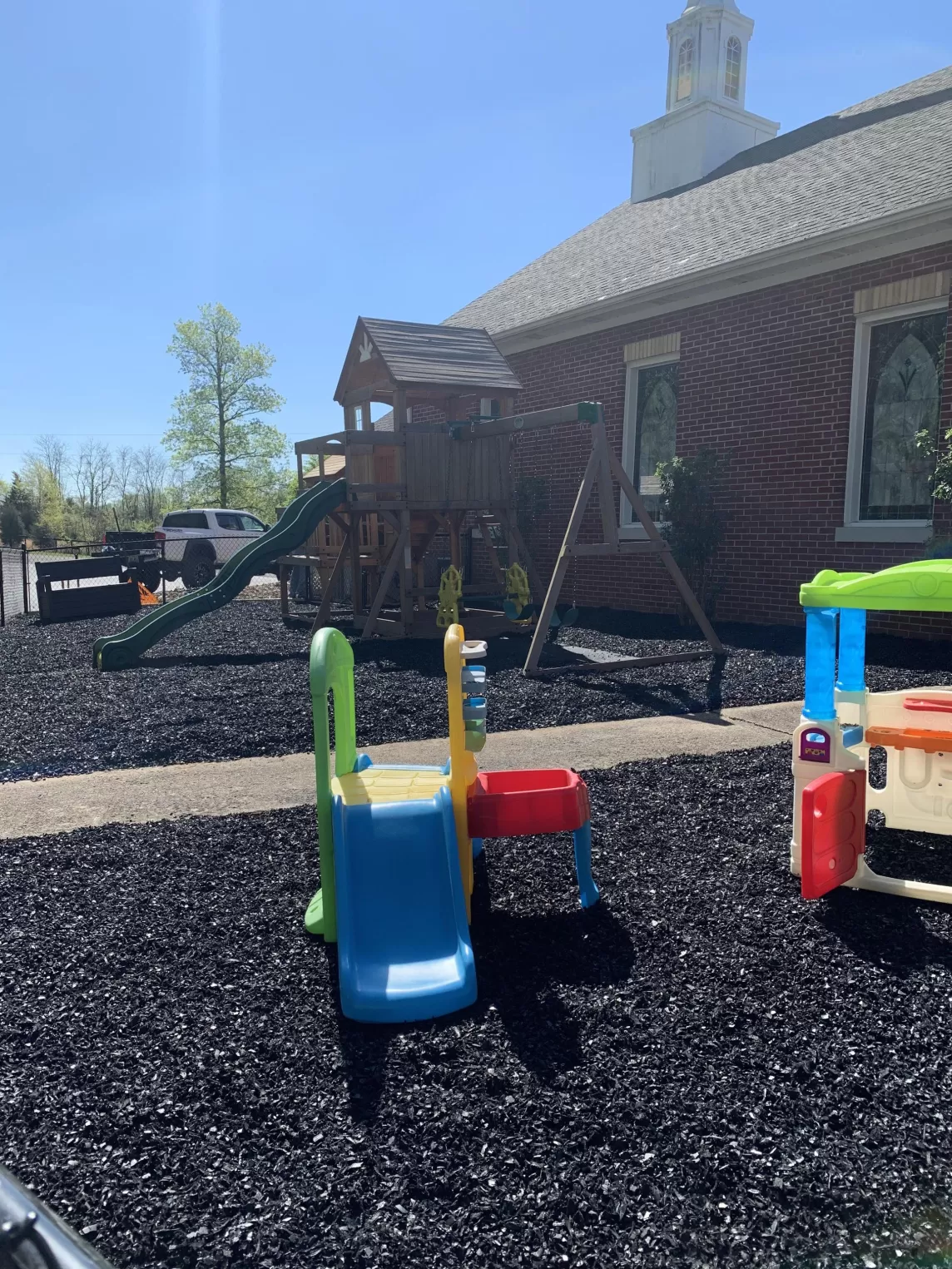 Church playground with black rubber mulch