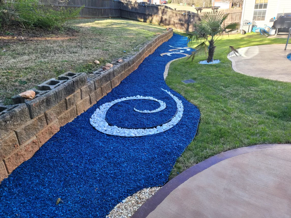 Pool landscaping with blue rubber mulch