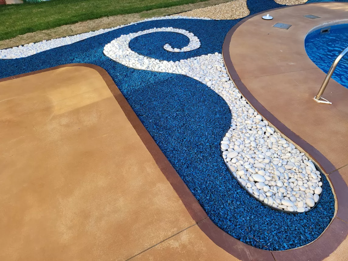 Blue rubber mulch design around a pool