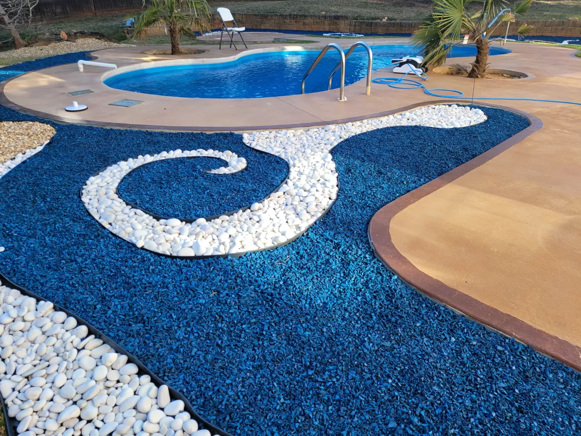 Pool with blue rubber mulch landscaping