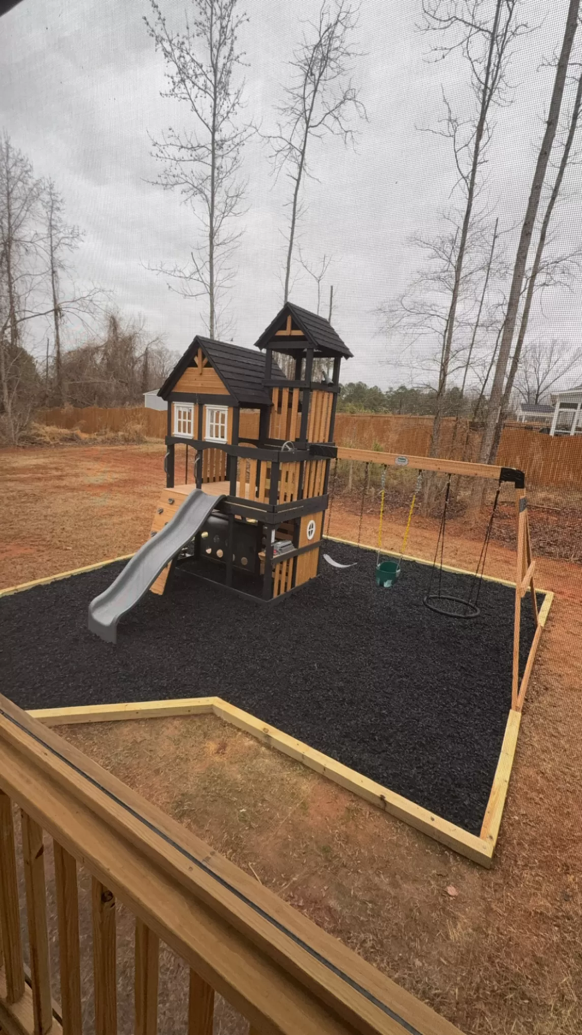 Playground with black rubber mulch ground cover