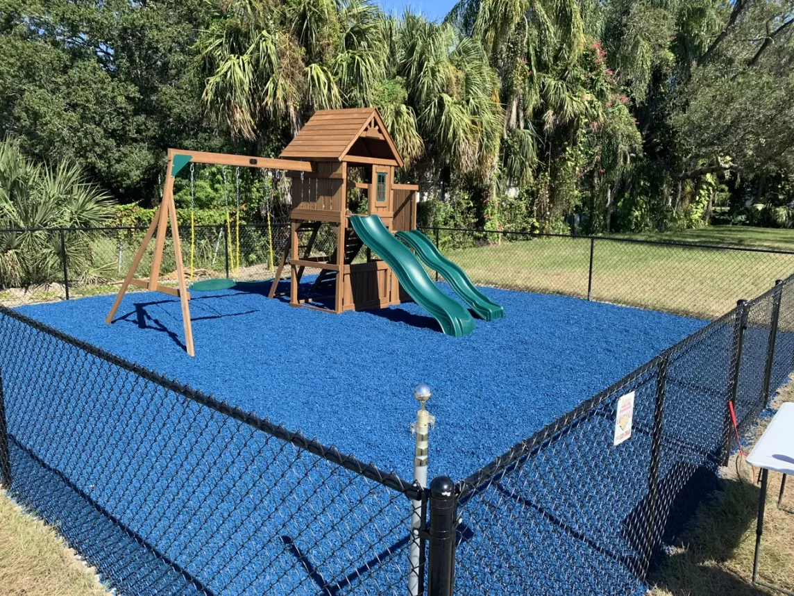 Playground with blue rubber mulch ground cover
