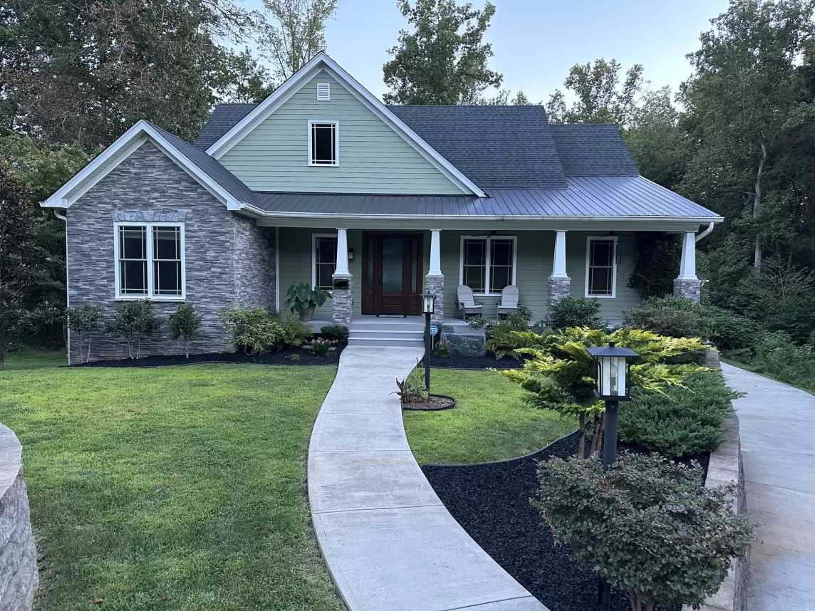 Beautiful house with black rubber mulch landscaping