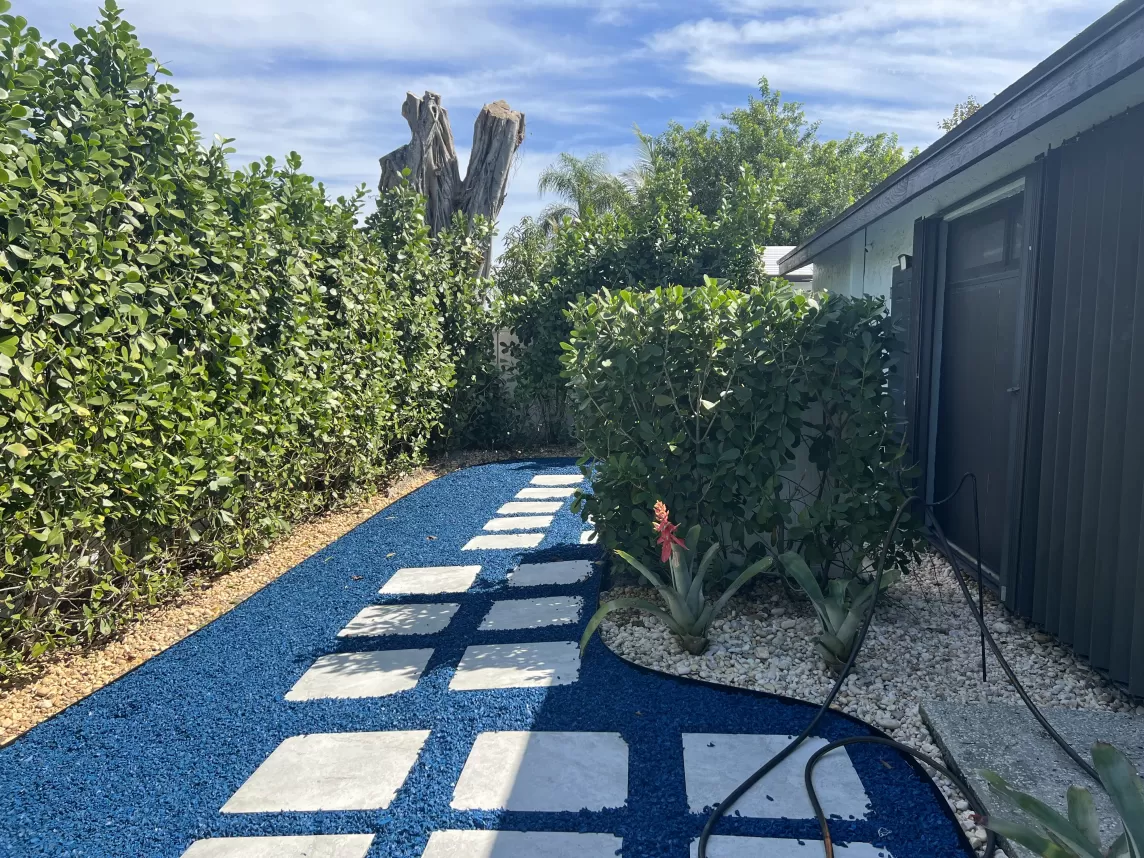 Stone paver path with blue rubber mulch fill