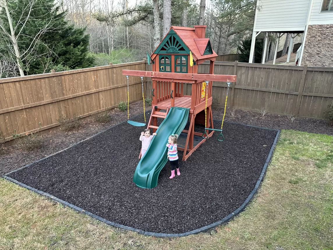 Brown Rubber Mulch Playground in Backyard