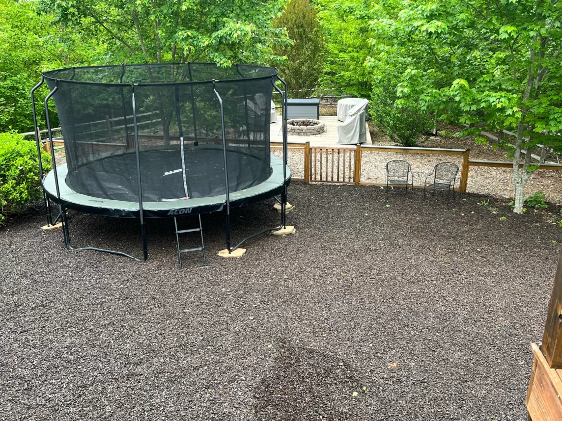 Trampoline playscape with brown rubber mulch