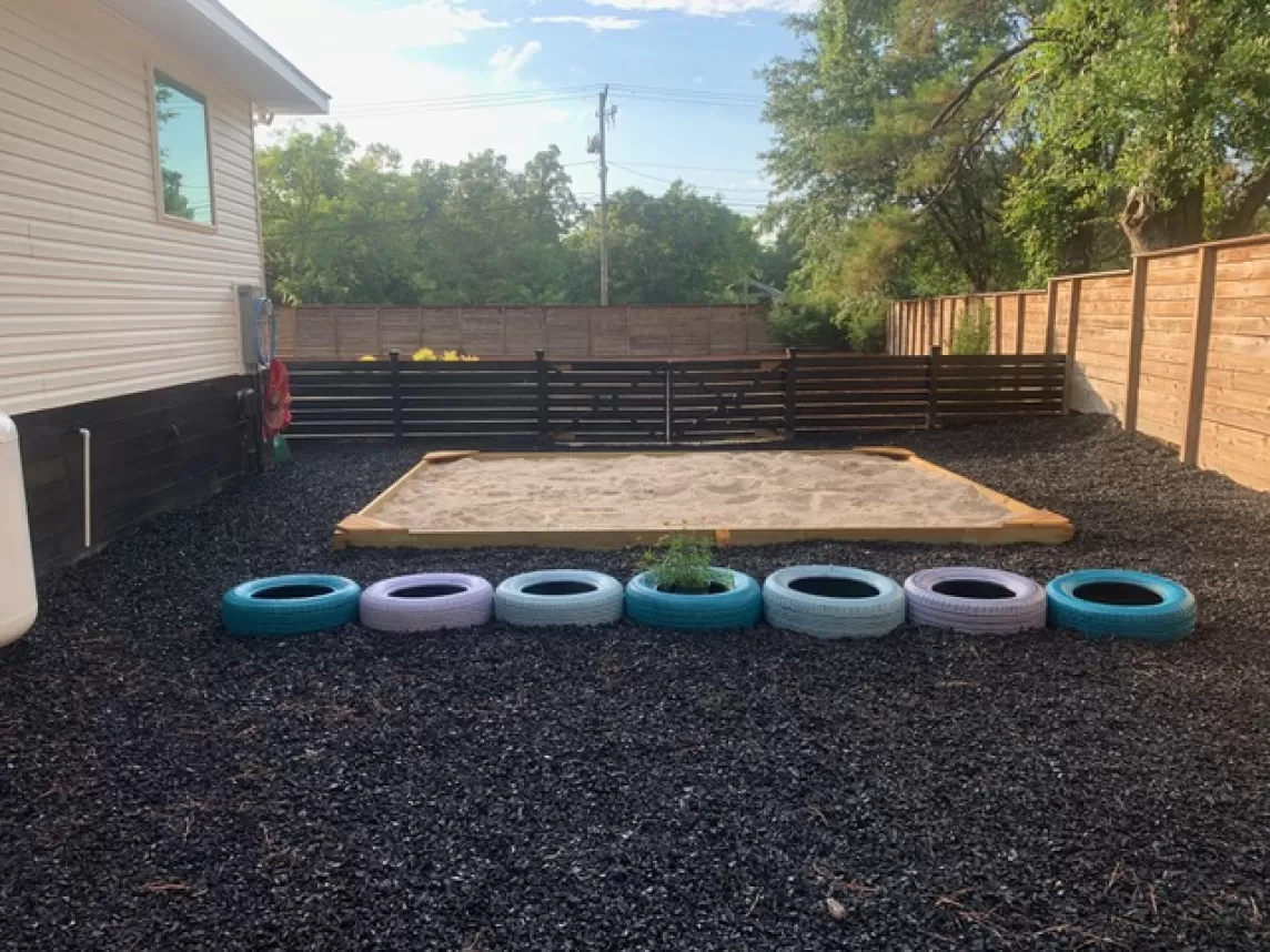 Sandbox with rubber mulch surrounding