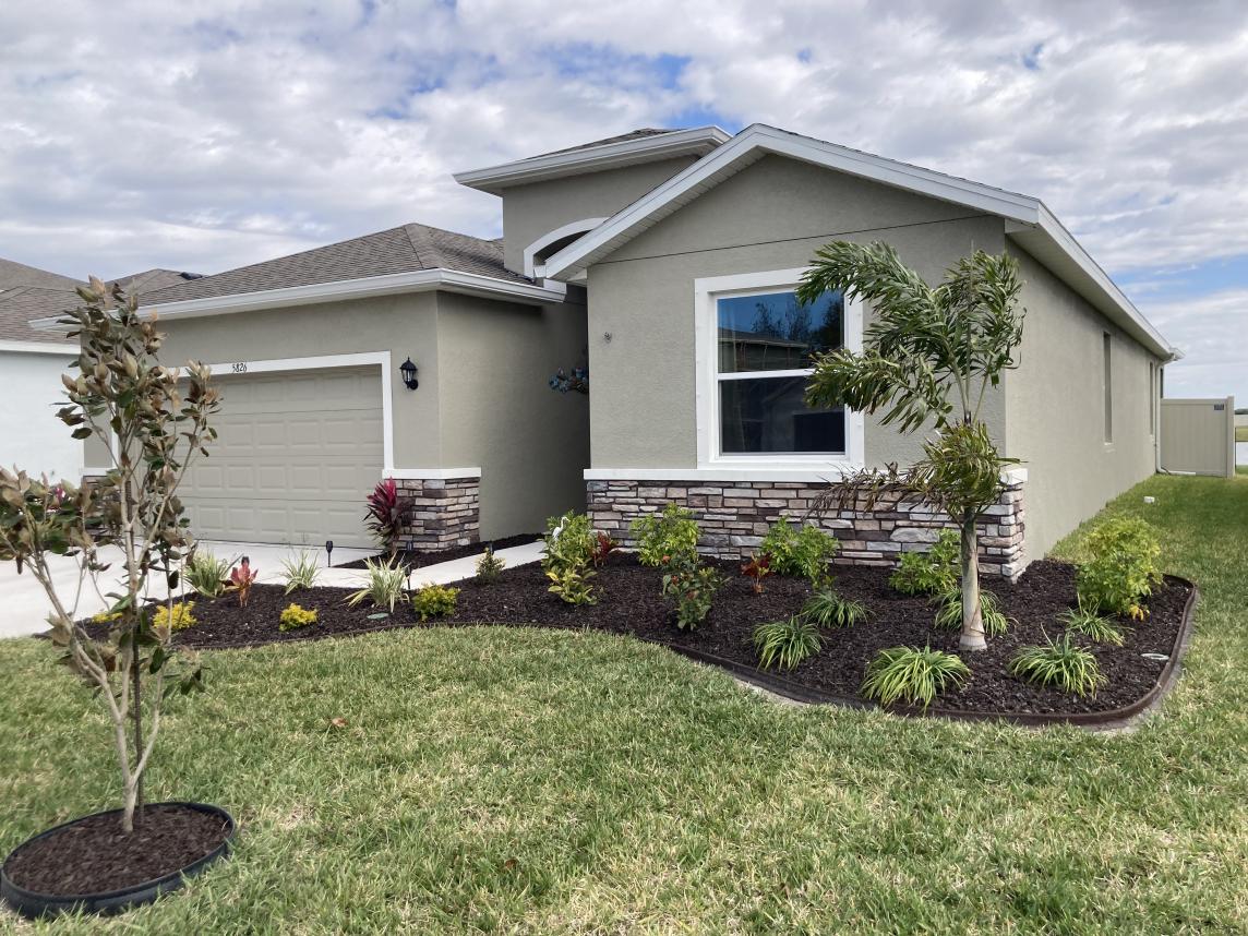 House with Brown Rubber Mulch Landscaping