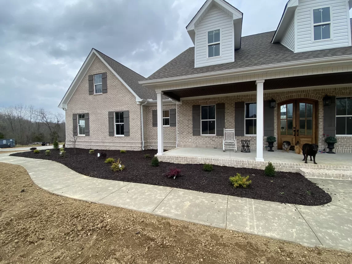 Rubber Mulch garden bed landscaping in front of house