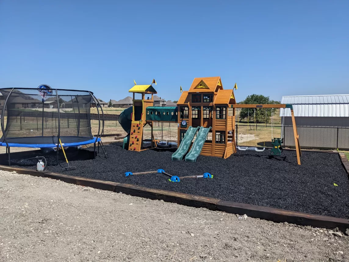 Play area covered with black rubber mulch