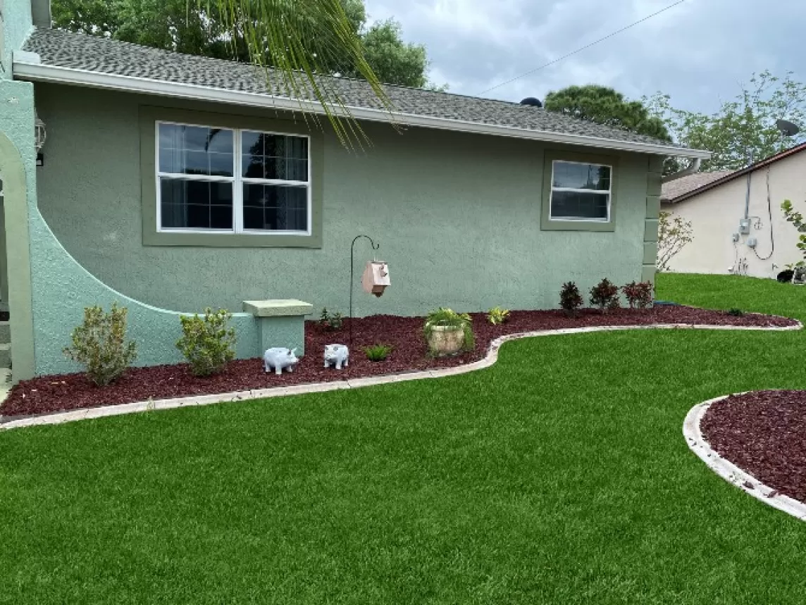 Landscaping with Red Rubber Mulch Beds Against the House
