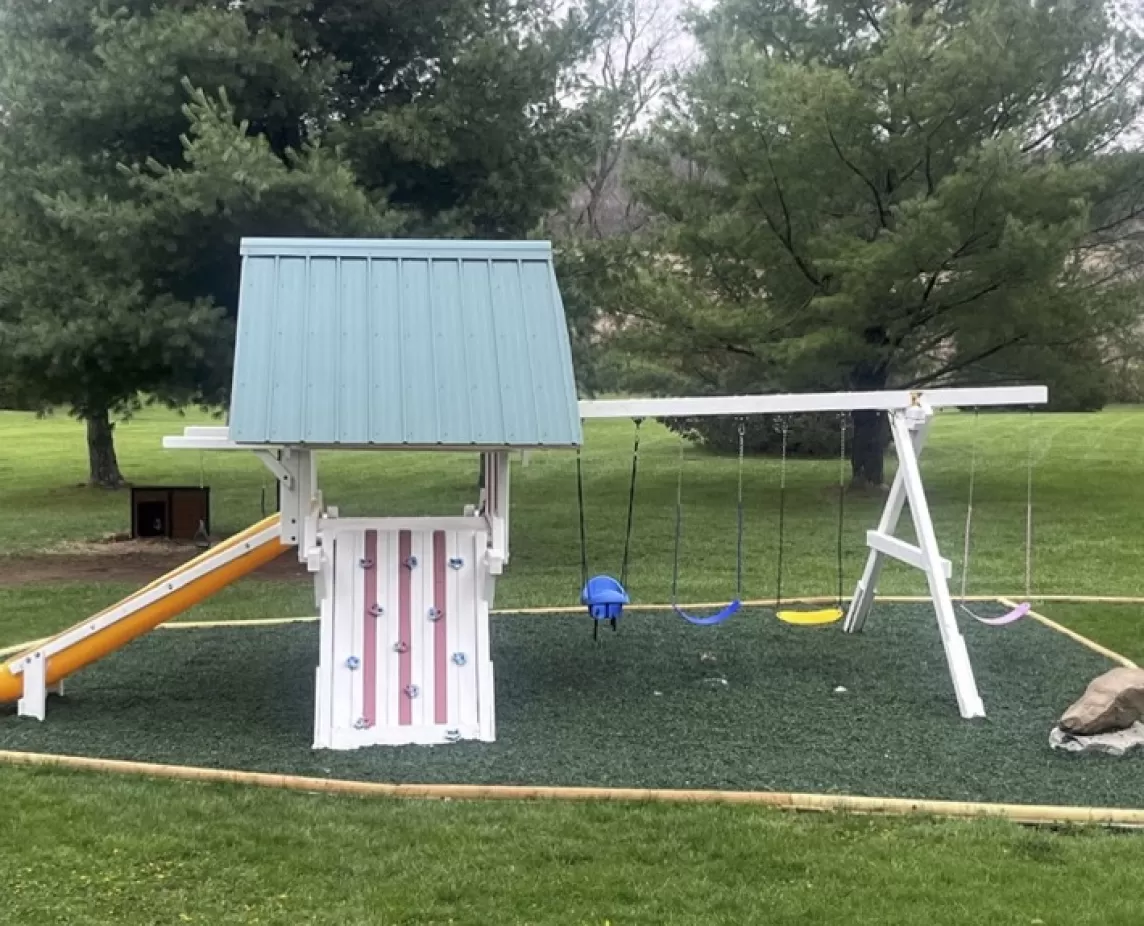 Playground with green rubber mulch ground cover