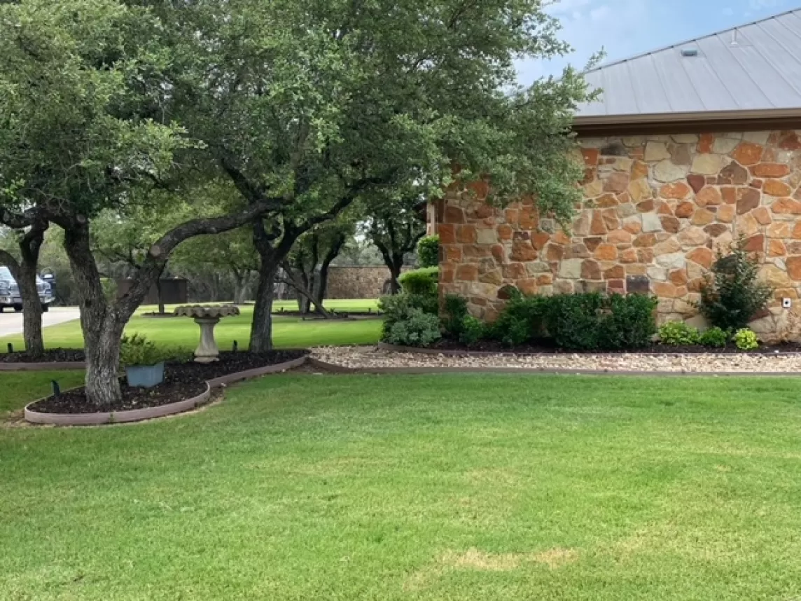 Brown rubber mulch in front yard of landscaping