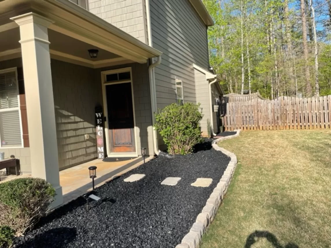 Front yard black rubber mulch garden bed