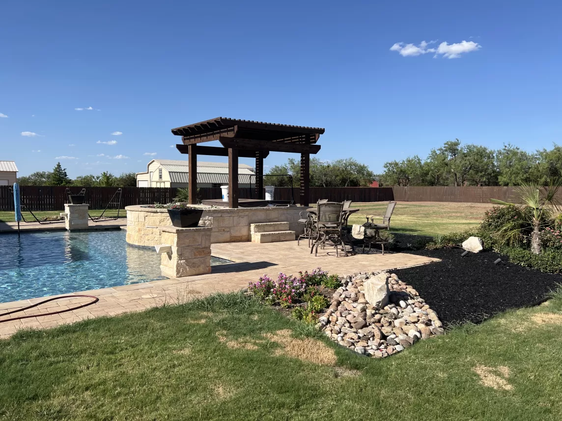 Pool that is using black rubber mulch for landscaping