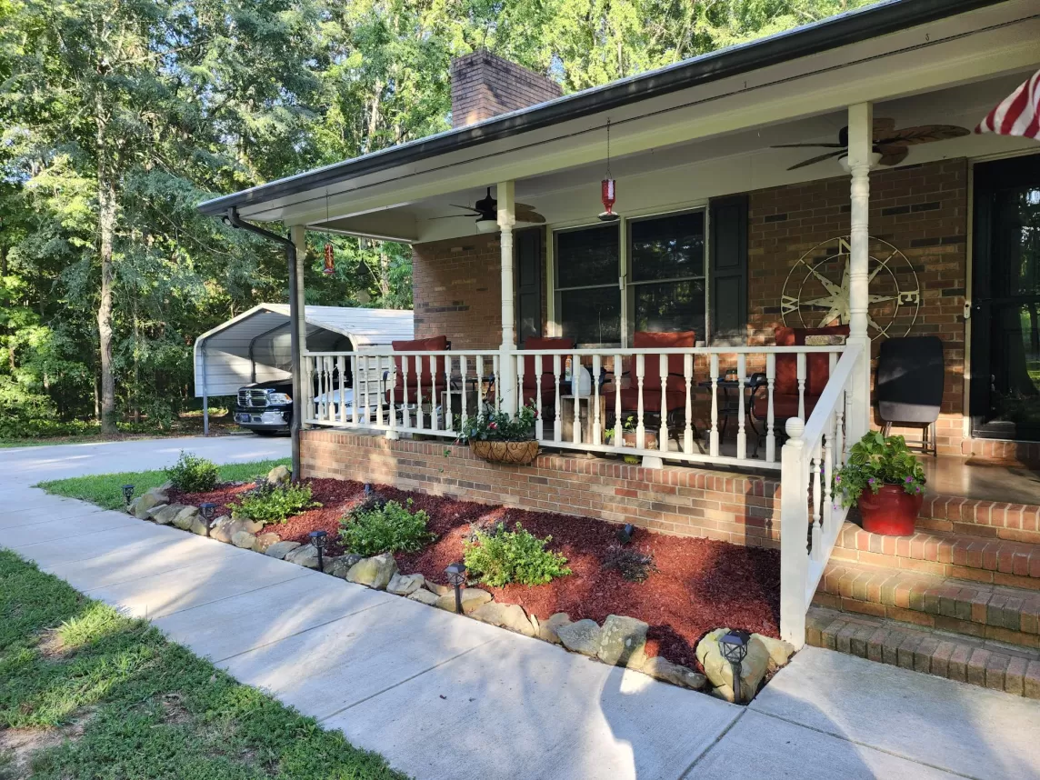 Red rubber mulch landscaping in front of patio
